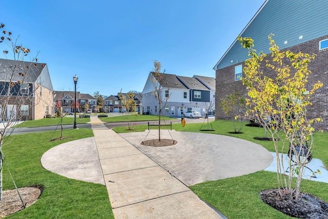 view of home's community featuring a residential view and a lawn