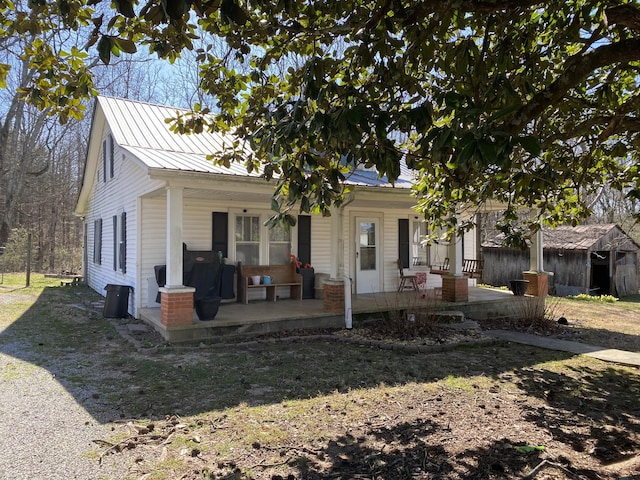 view of front of property featuring a porch and metal roof