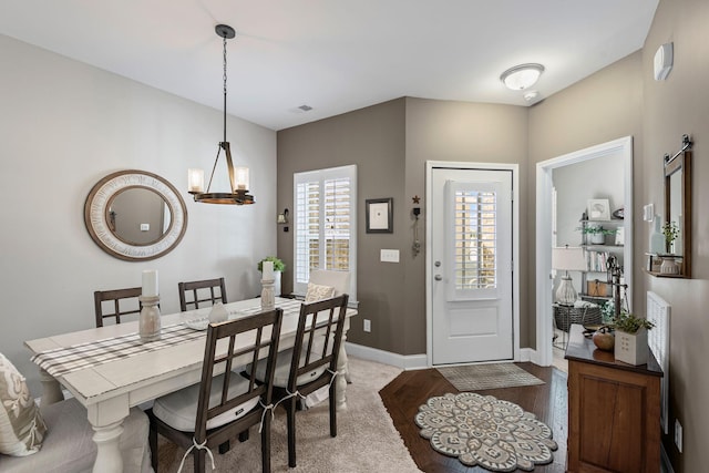 dining area with visible vents, baseboards, and a chandelier