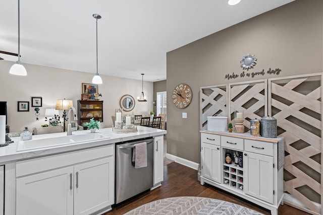 kitchen featuring a sink, stainless steel dishwasher, white cabinets, and dark wood finished floors