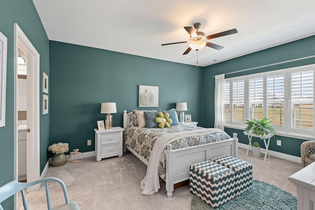 carpeted bedroom with a ceiling fan and baseboards