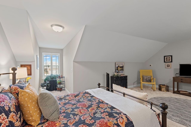 carpeted bedroom with lofted ceiling and baseboards