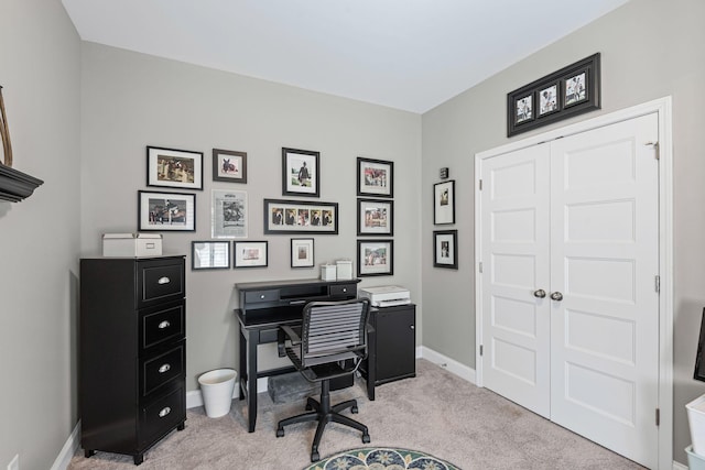 office space featuring light colored carpet and baseboards