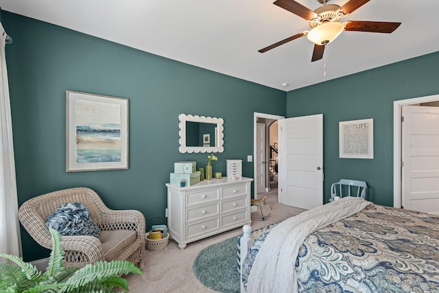 bedroom featuring light carpet and a ceiling fan