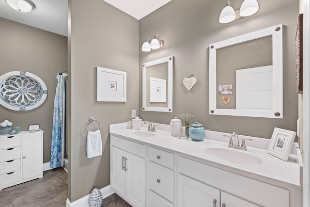 full bath with a sink, a shower with shower curtain, double vanity, and tile patterned flooring