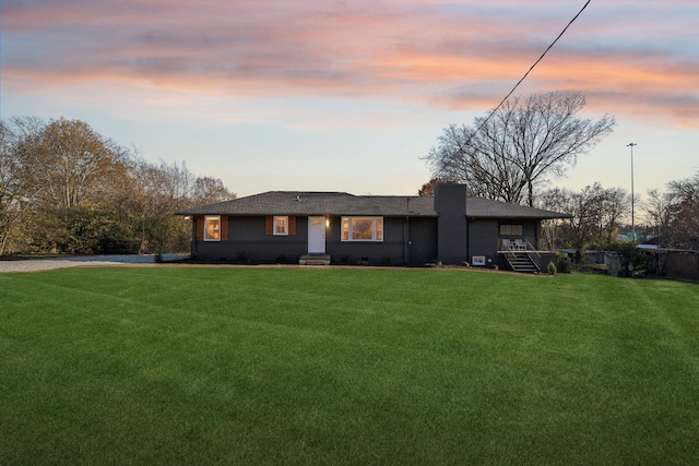 ranch-style home with crawl space, a chimney, and a front lawn