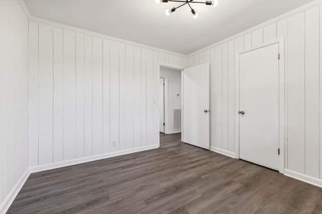 unfurnished bedroom featuring visible vents, dark wood-type flooring, and crown molding