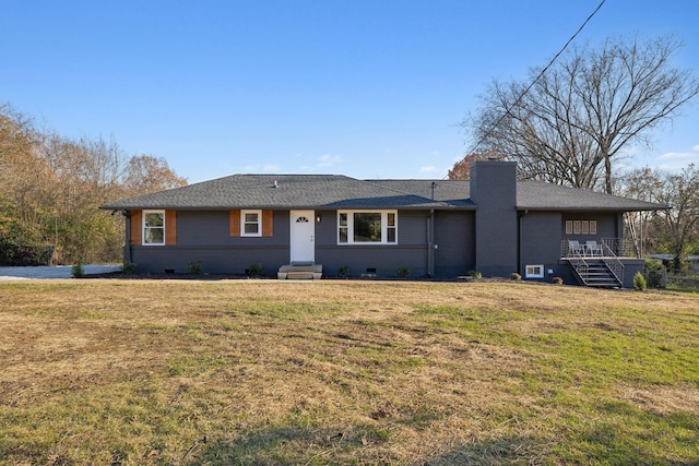 view of front facade featuring crawl space, a chimney, a front lawn, and brick siding