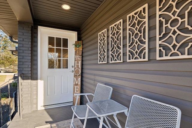 view of exterior entry with covered porch