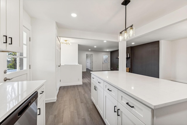 kitchen featuring stainless steel dishwasher, wood finished floors, recessed lighting, white cabinets, and light countertops