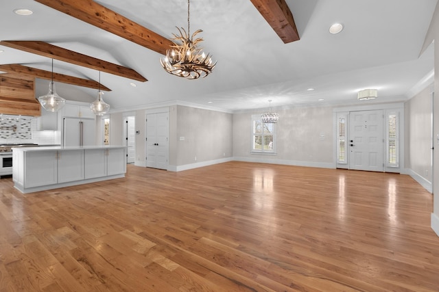 unfurnished living room featuring light wood-style flooring, lofted ceiling with beams, crown molding, baseboards, and a chandelier