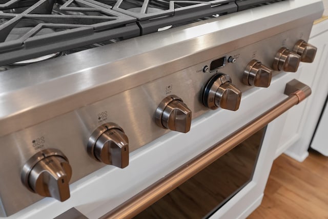 details featuring stove and wood finished floors