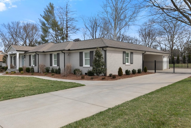 view of front of house with brick siding, fence, a front yard, driveway, and a gate