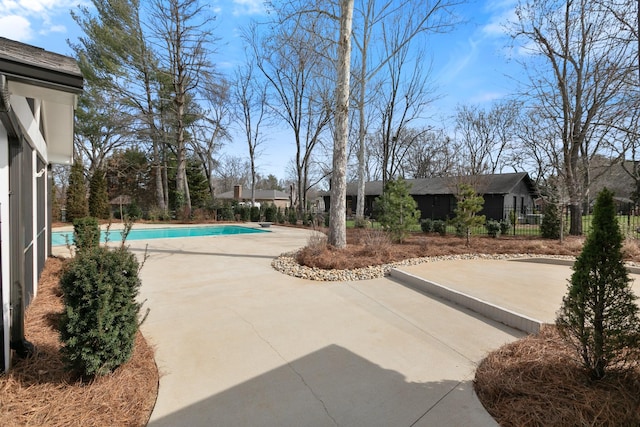 view of swimming pool featuring a fenced in pool, a patio, and fence