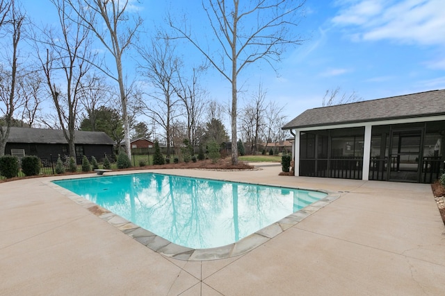 view of swimming pool featuring a fenced in pool, a patio, fence, and a sunroom