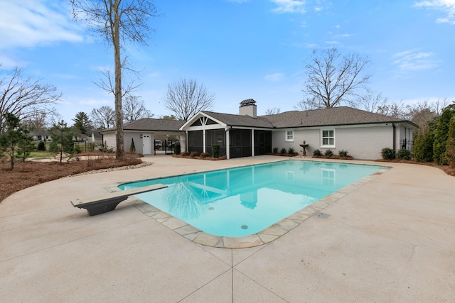 pool with a diving board, a patio, and a sunroom