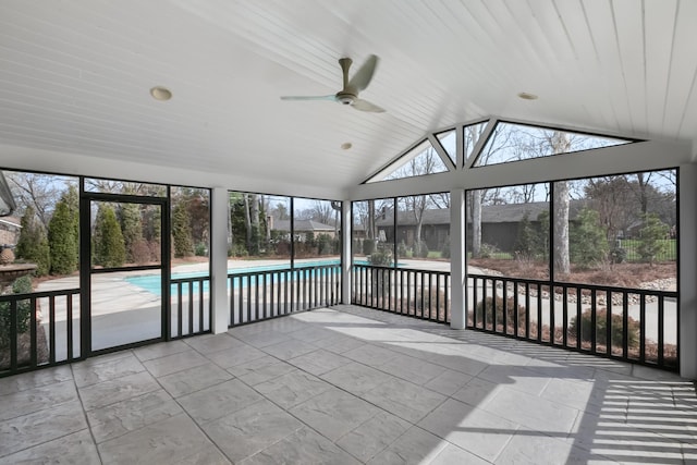 unfurnished sunroom with vaulted ceiling, plenty of natural light, and a ceiling fan