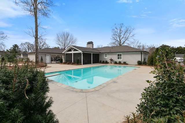 pool with a diving board, a patio area, fence, and a sunroom