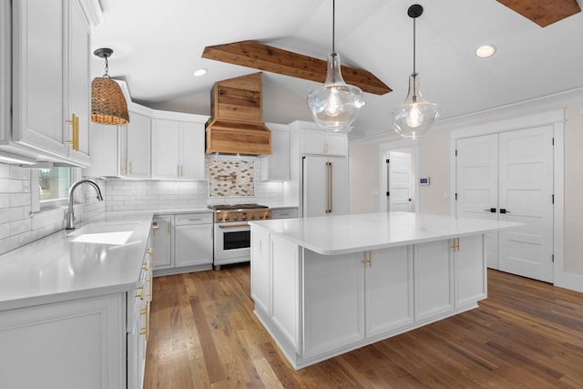 kitchen featuring custom exhaust hood, a sink, vaulted ceiling, white cabinetry, and high quality appliances