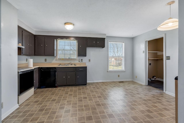 kitchen with dark brown cabinets, light countertops, black dishwasher, range with electric stovetop, and a sink