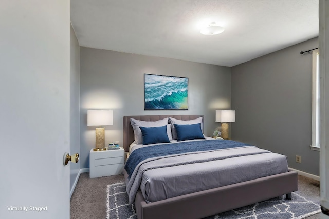 bedroom featuring baseboards and carpet flooring