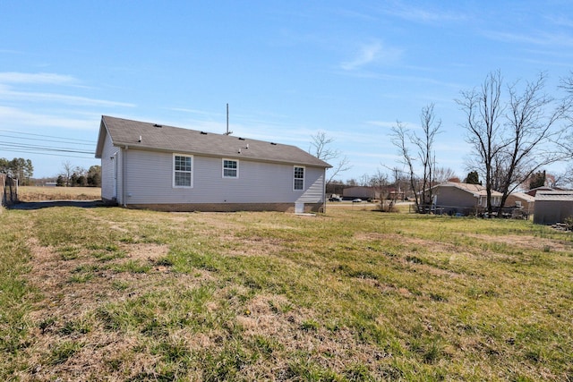 back of property featuring a lawn