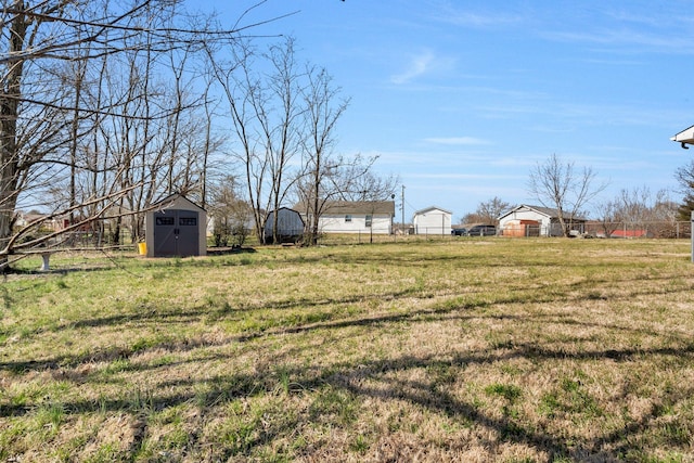 view of yard featuring a storage shed and an outbuilding