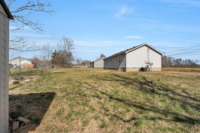 view of yard with cooling unit and fence