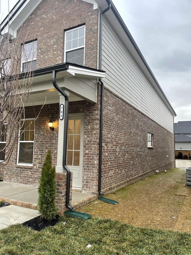 view of side of home with brick siding