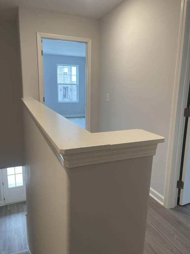 corridor with dark wood-style floors and baseboards