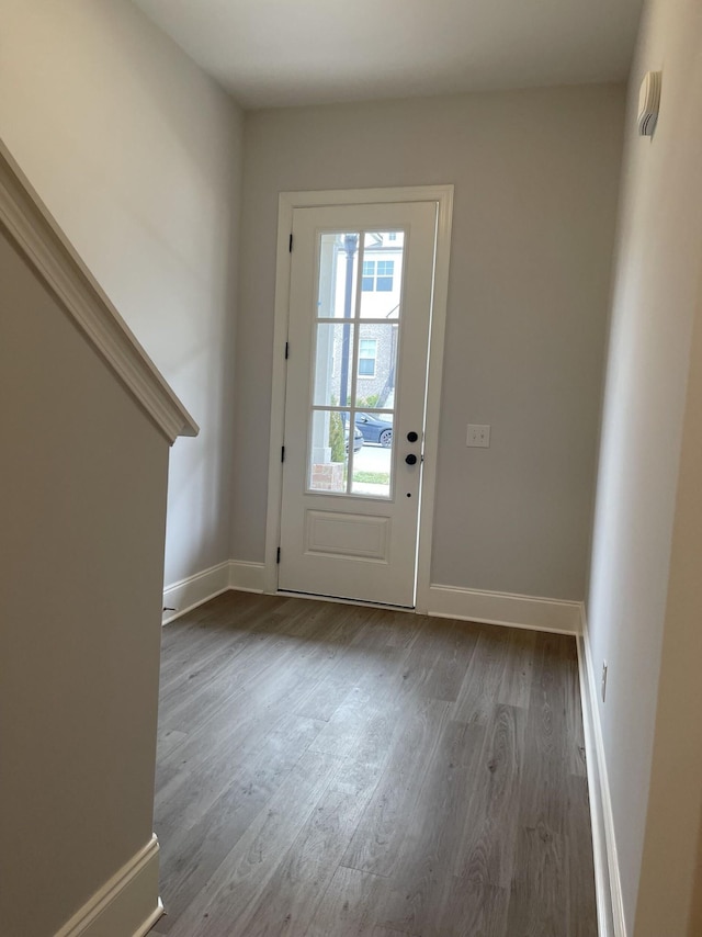 entryway with baseboards and wood finished floors