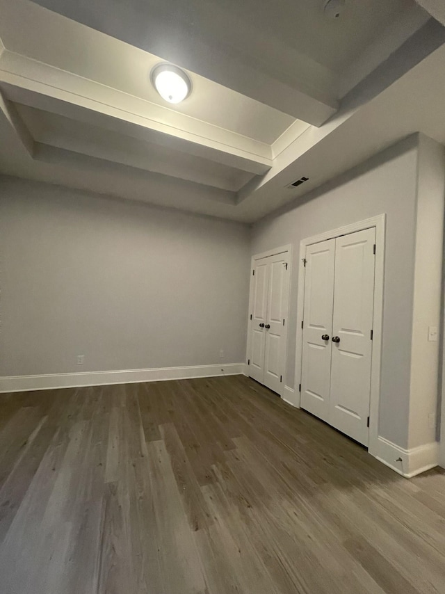 interior space with visible vents, baseboards, and dark wood-style flooring