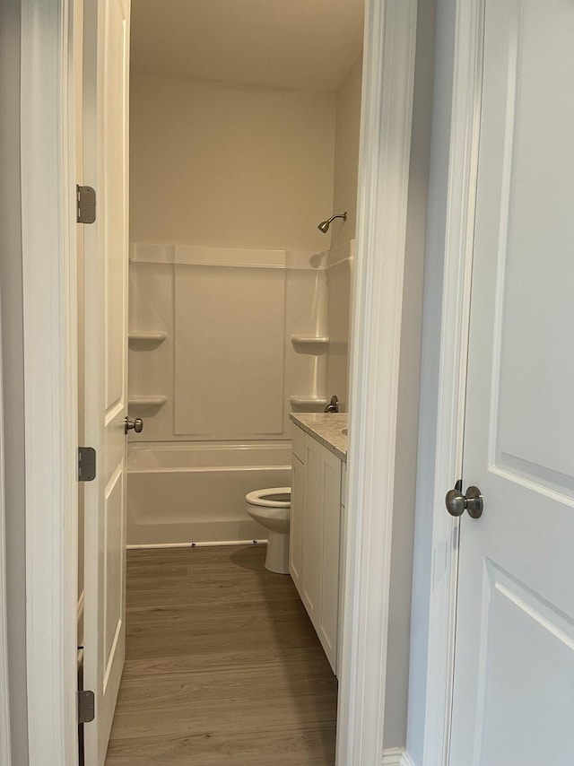 full bathroom with vanity, toilet, shower / bathing tub combination, and wood finished floors