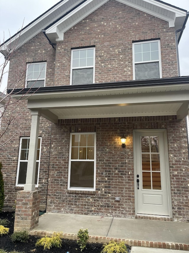 entrance to property with brick siding