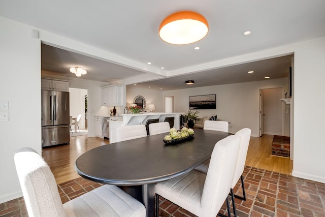 dining space with recessed lighting, brick floor, and baseboards