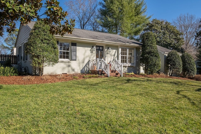 ranch-style house featuring a front yard, brick siding, roof with shingles, and crawl space