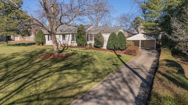 ranch-style house featuring a detached garage, an outbuilding, a front yard, and fence