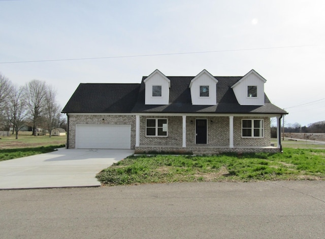 cape cod-style house featuring brick siding, a porch, concrete driveway, and an attached garage