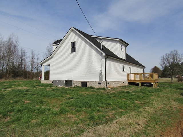 view of home's exterior with a wooden deck, a lawn, central AC, and crawl space