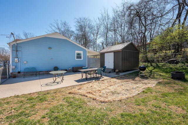 back of property with a patio, a shed, fence, a yard, and an outdoor structure