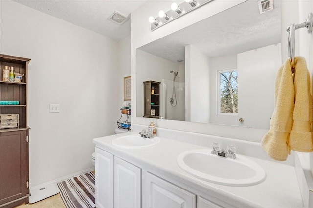 full bathroom with a sink, visible vents, and walk in shower