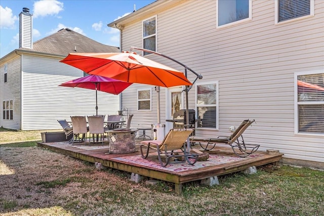 wooden terrace with a lawn