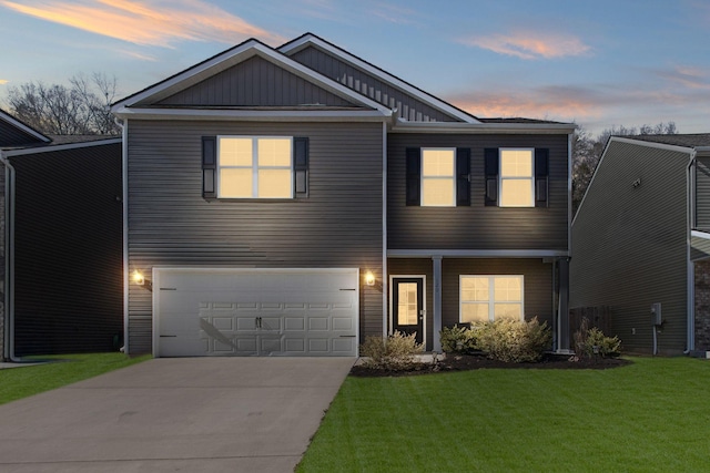 view of front of house featuring a yard, board and batten siding, concrete driveway, and an attached garage