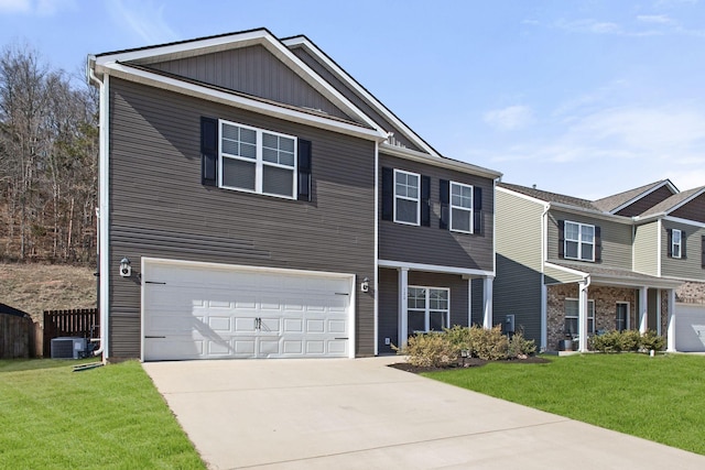 view of front of home featuring an attached garage, concrete driveway, a front lawn, and fence