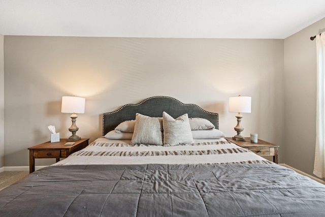 bedroom featuring baseboards and carpet floors