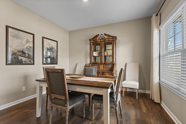 dining space featuring baseboards and wood finished floors