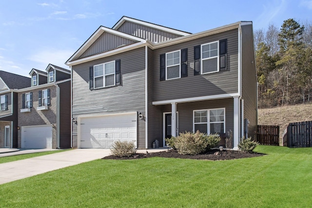 view of front of home featuring a front yard, fence, driveway, a garage, and board and batten siding