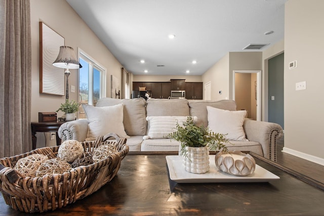 living room with recessed lighting, visible vents, baseboards, and dark wood-style floors