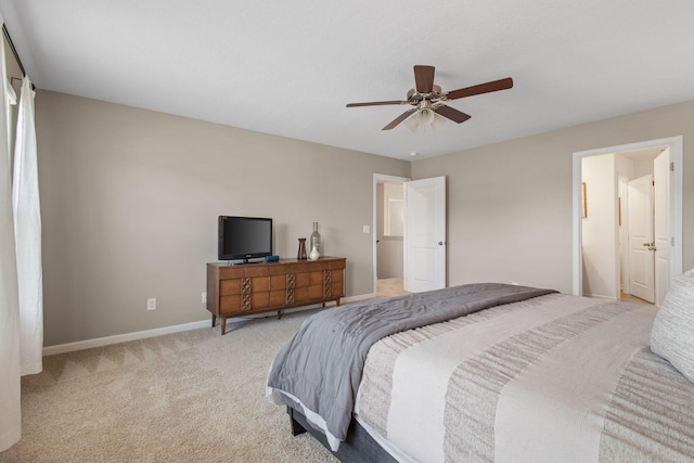 bedroom with light colored carpet, a ceiling fan, and baseboards