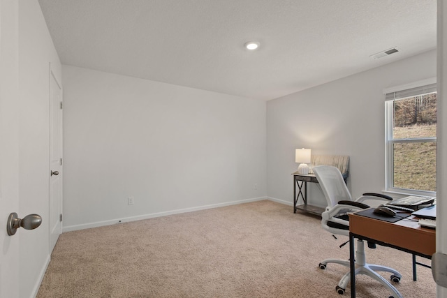 office area featuring visible vents, baseboards, and carpet